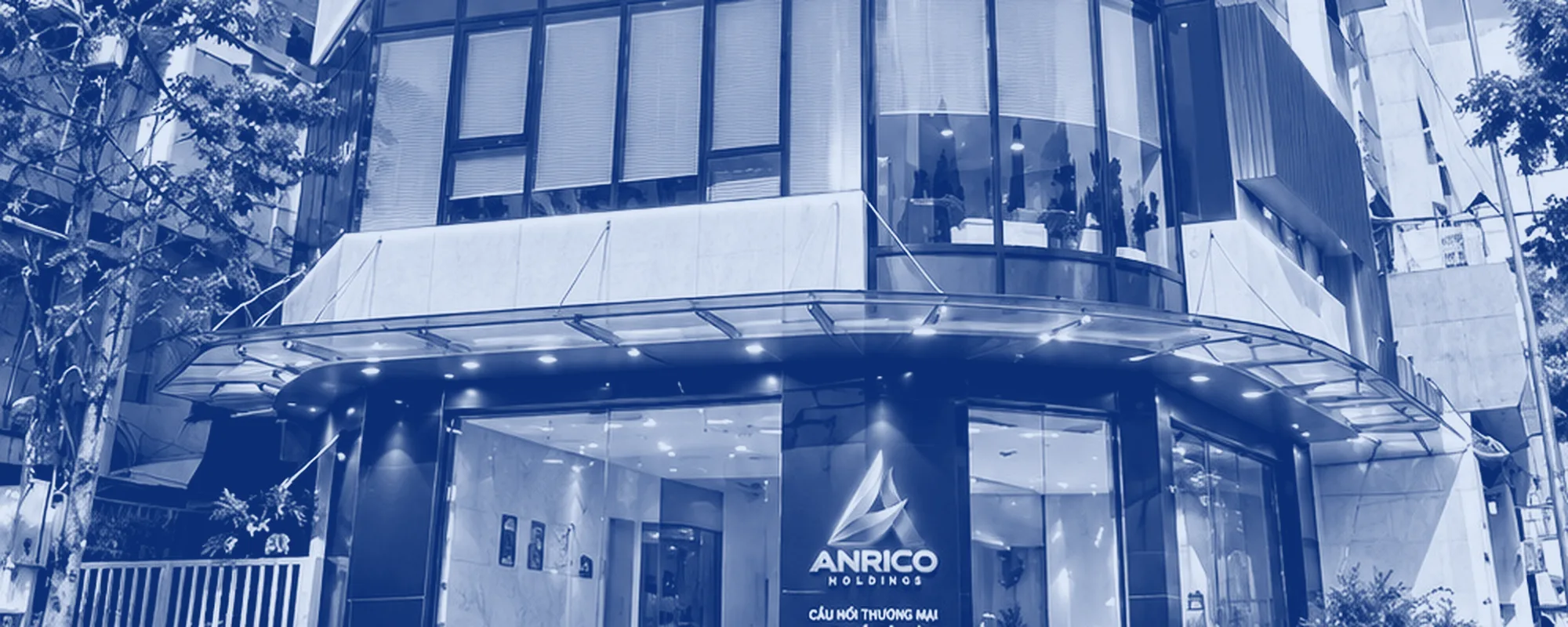 The ANRICO HOLDINGS head office frontage: the canopy, the lower glass and the trees along the street